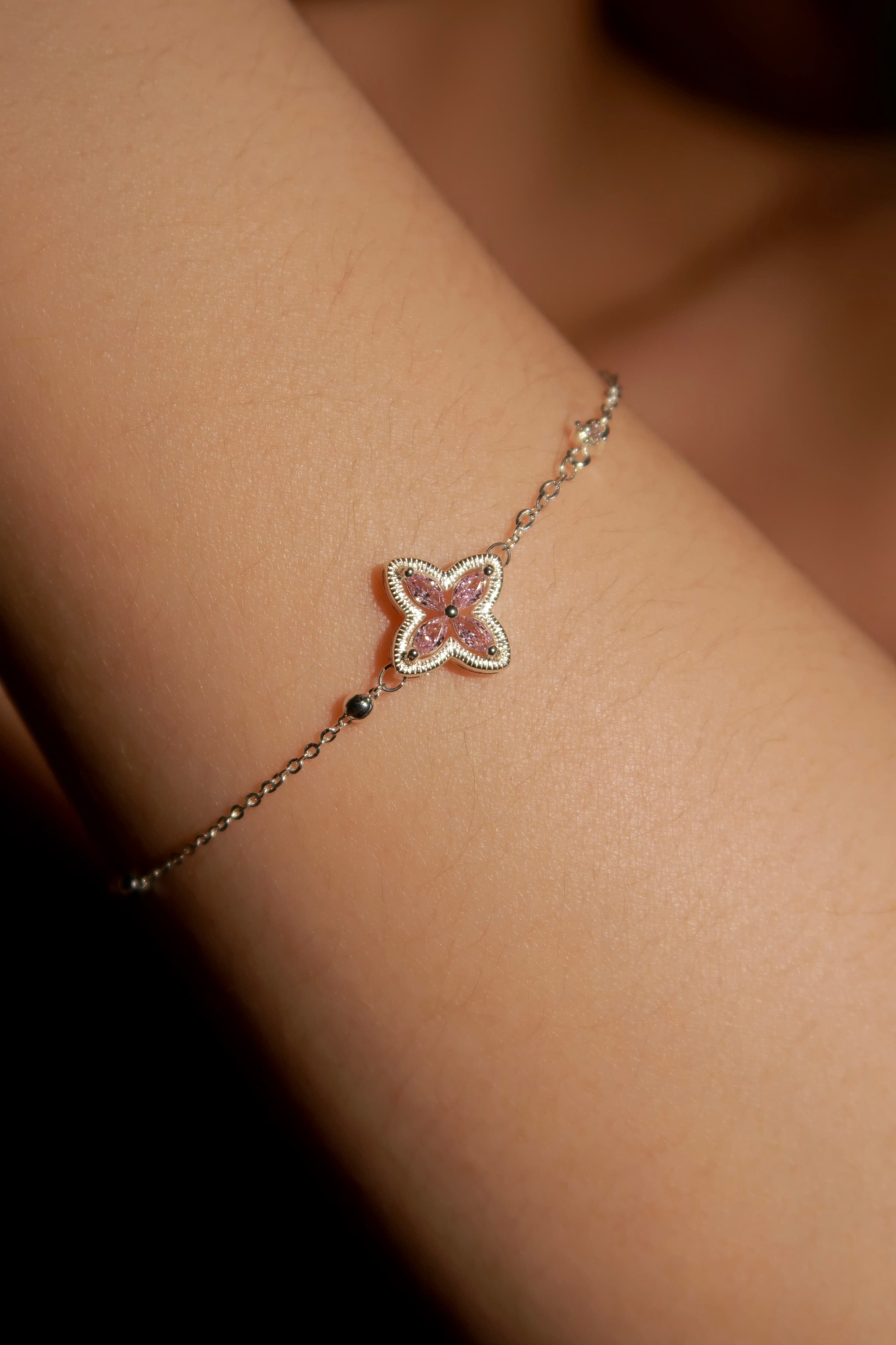 Star-shaped bracelet on a wrist with a blurred background