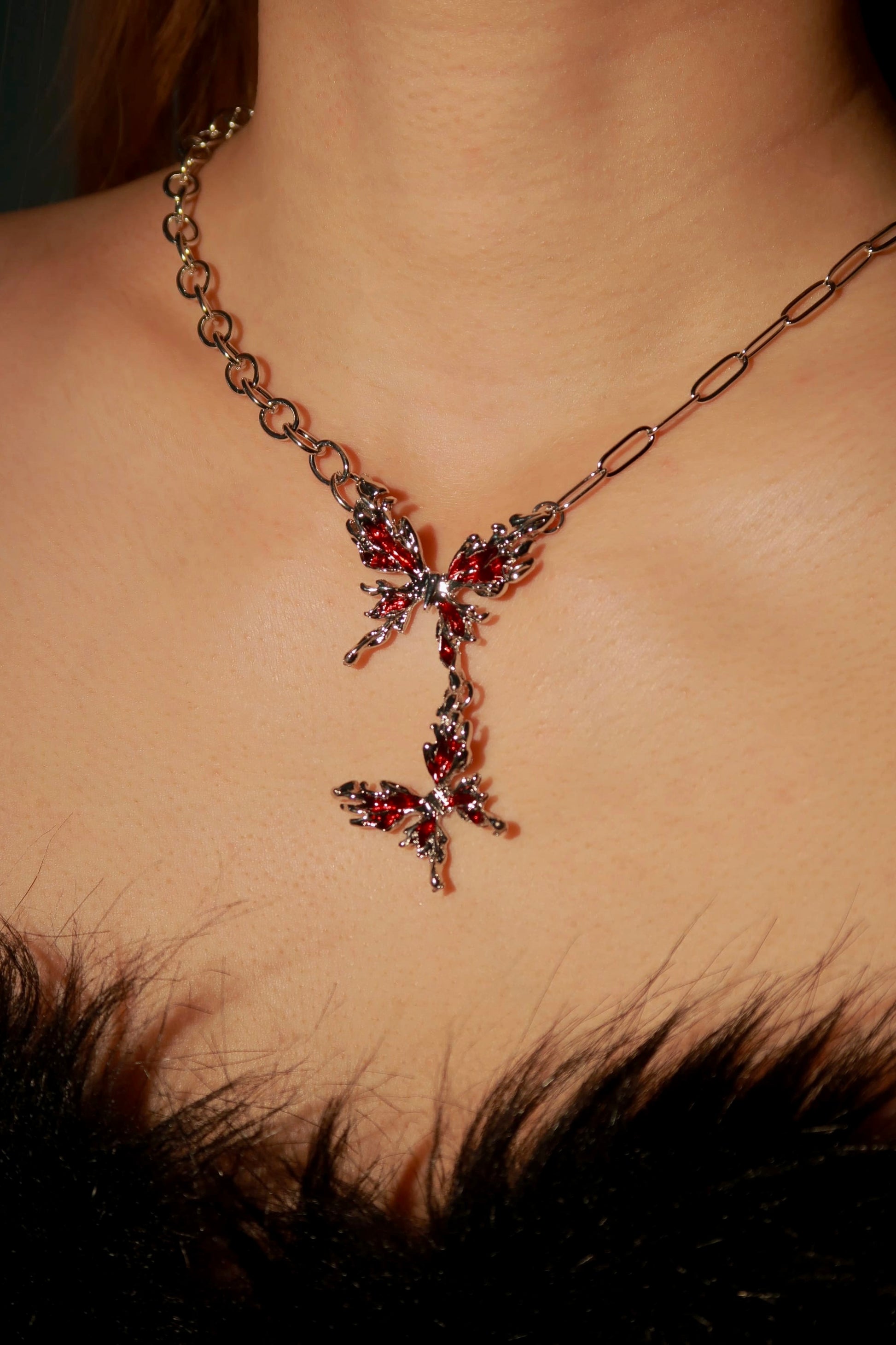 Necklace with red gemstones on a person's neck