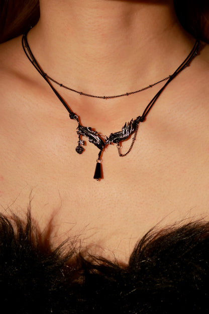 Necklace with a pendant on a person's neck against a dark background