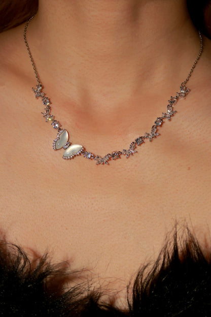 Necklace with butterfly pendant on a person's neck