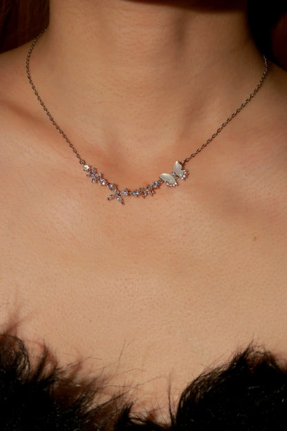 Necklace with butterfly pendant on a person's neck