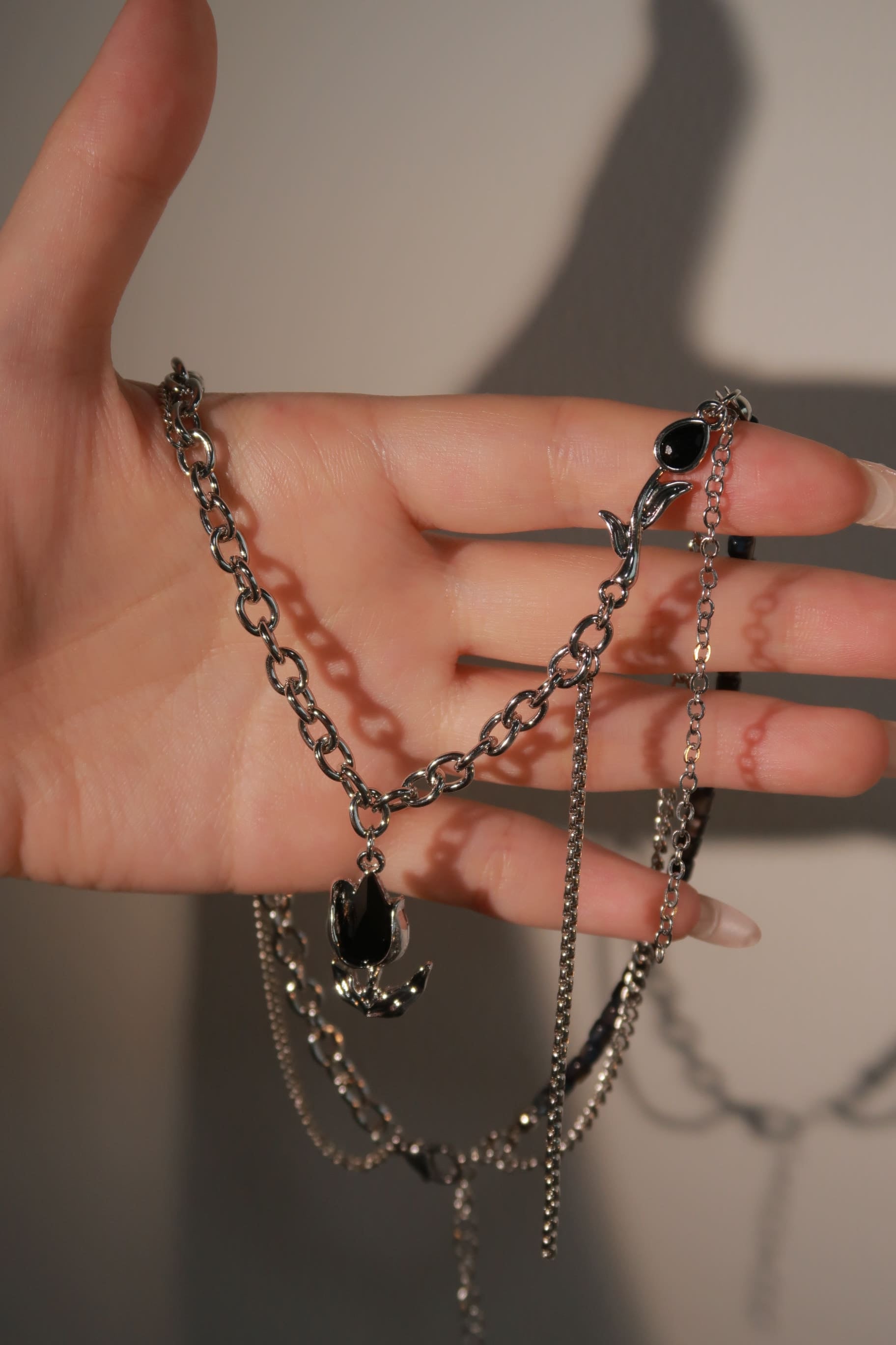 Black Gemstone Droplet Flower Necklace on hand