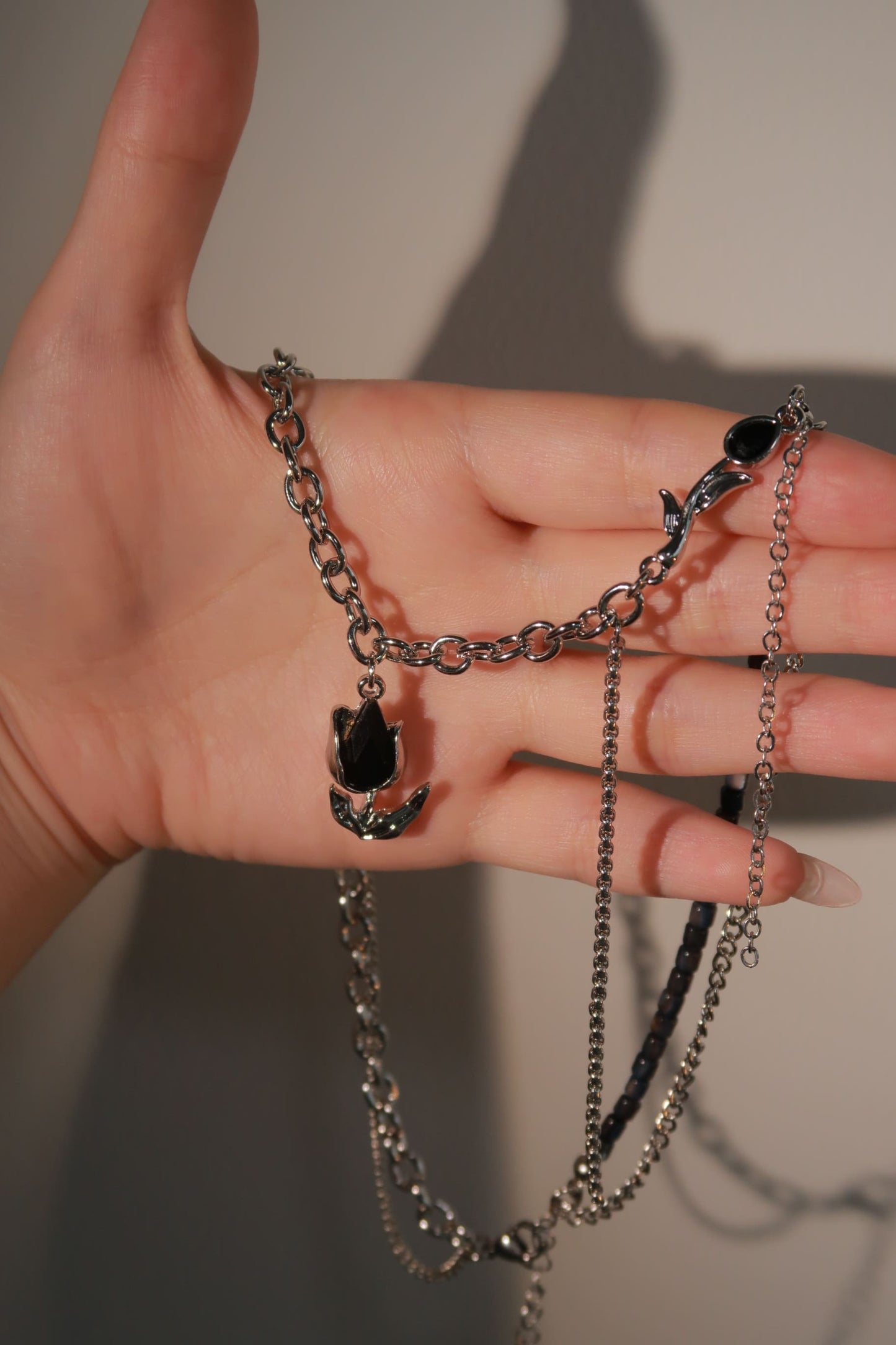 Black Gemstone Droplet Flower Necklace on hand