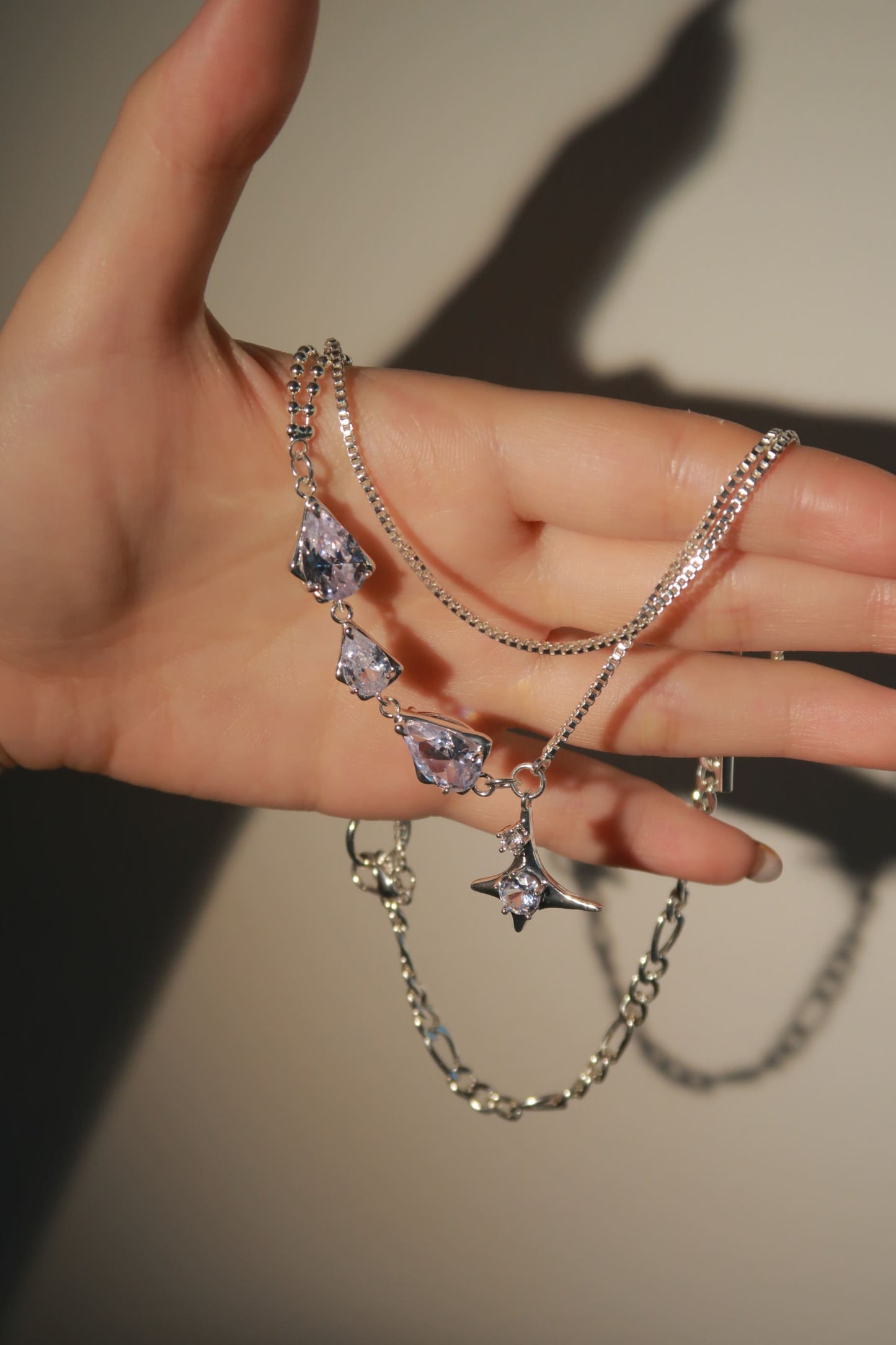 Crystal Stellar Necklace holding on hand