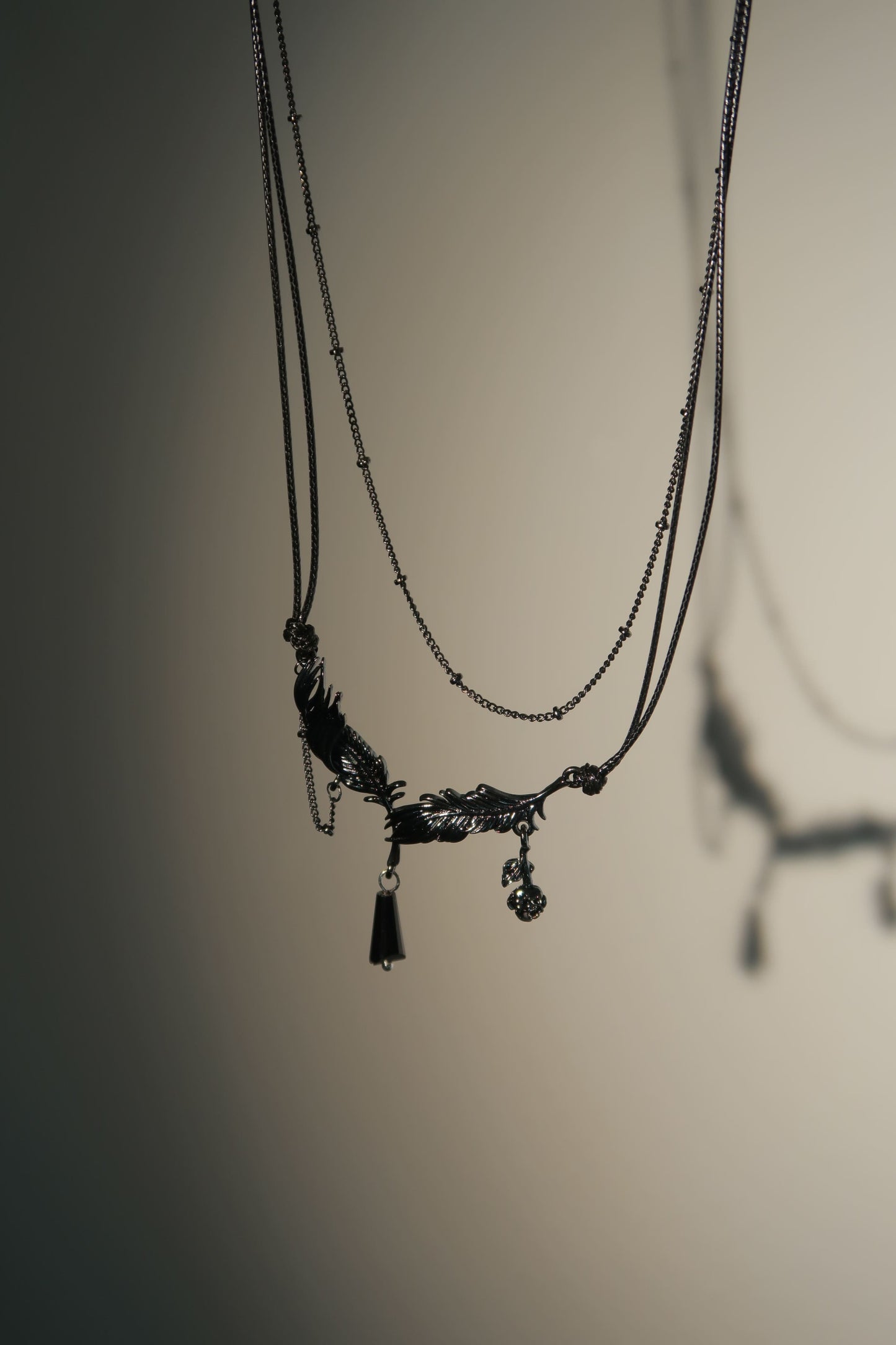 Necklace with a pendant on a reflective surface